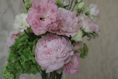 Gently bouquet of flowers with hydrangea, peony, viburnum and eustomas, close up.