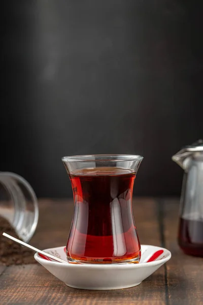 Freshly brewed turkish tea in front of dark background