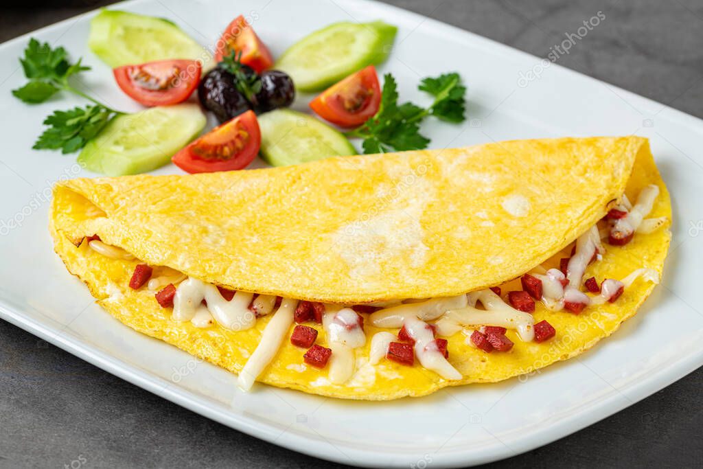 Tortilla con queso feta y salchicha turca en un plato de porcelana
