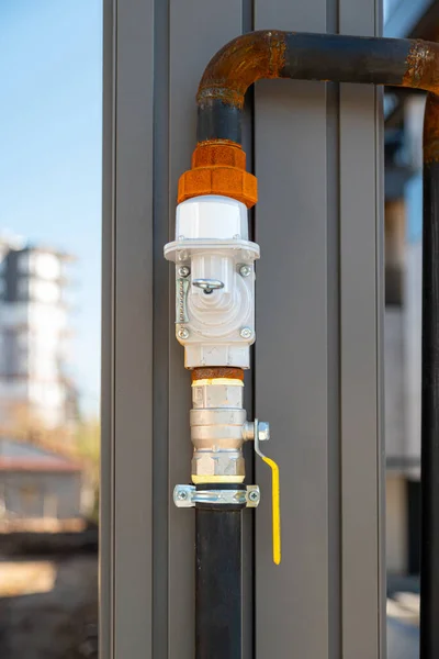 Natural gas pipe and valve mounted on the building column