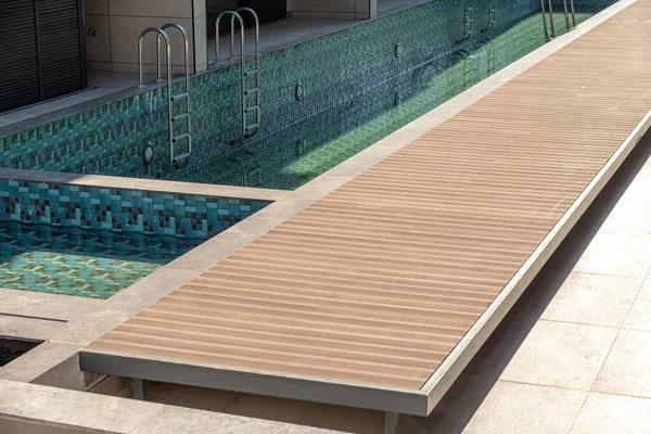 Composite deck installed on the edge of the swimming pool