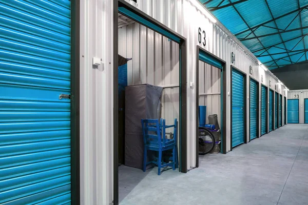 Corridor of self storage unit with blue doors. Rental Storage Units