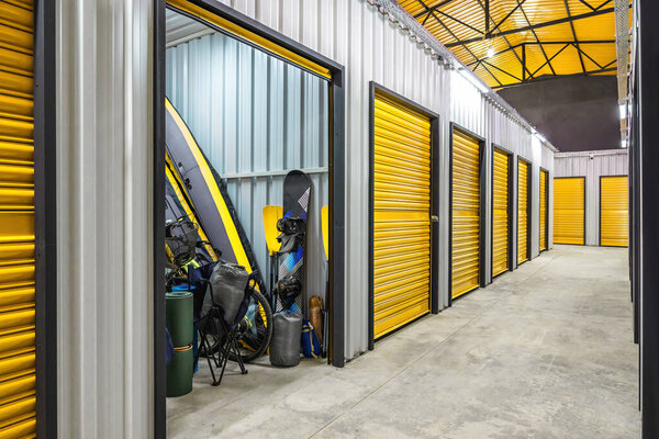 Corridor of self storage unit with yellow doors. Rental Storage Units