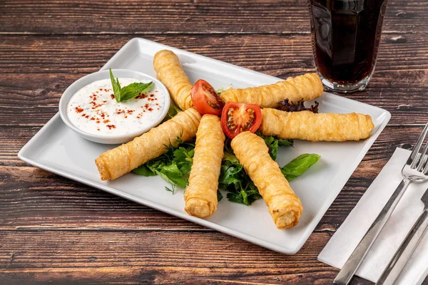 stock image Turkish Cigar Shaped Rolls on a white porcelain plate. The Turkish name is Sigara Boregi