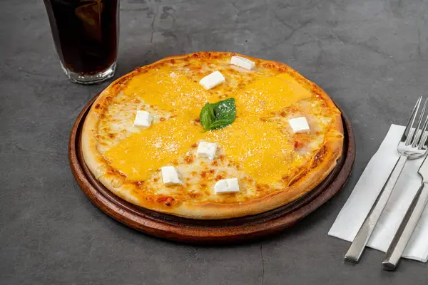 stock image Italian pizza with four cheeses and lots of mozzarella on a cutting board