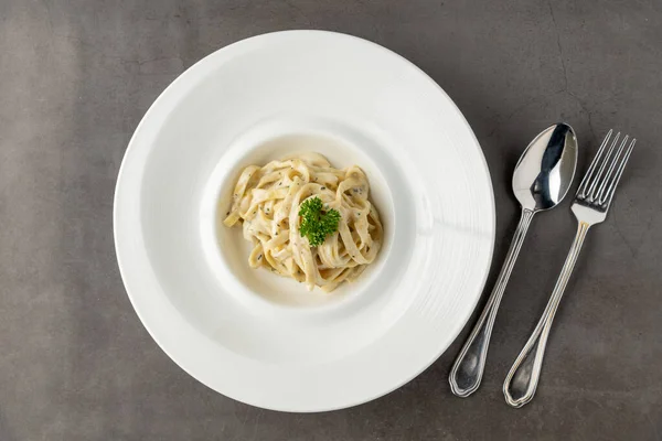 stock image Freshly made fettucini alfredo on a white porcelain plate