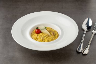 Parmesan cheese risotto on a white porcelain plate