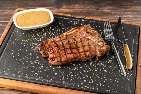 New York Strip Loin on stone cutting board at steak house