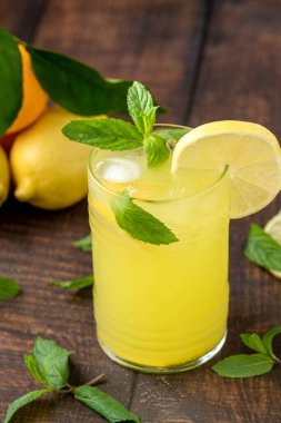 Ahşap masada cam camda buzlu limonata.