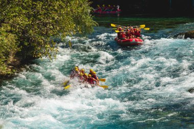 Antalya, Turkey - August 10, 2023: Rafting on a big rafting boat on the river in Antalya Koprulu Canyon. clipart