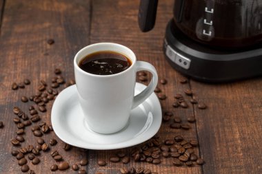 Filter coffee brewed in a filter coffee machine in a white porcelain cup clipart