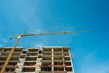 Construction crane working on large construction site