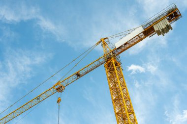 Construction crane working on large construction site