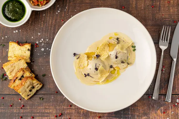 stock image Cheese ravioli with sauces on a white porcelain plate