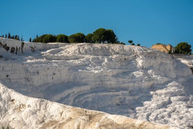 Natural travertine pools and terraces in Pamukkale. Travertines with no water left in their pools clipart