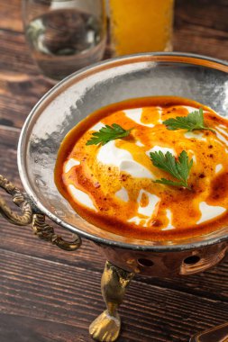 Poached egg Turkish name Cilbir, a classic Turkish dish, on a metal plate clipart