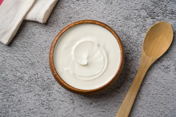 Gri taş masadaki yoğurdun en üst görüntüsü. Sağlıklı yeme kavramı