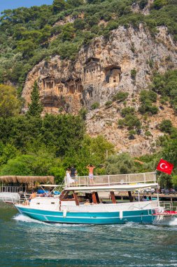 Kayalıklarda Kaunos kayalıkları manzaralı Dalyan Nehri 'ndeki tur teknesi.