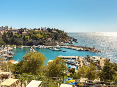 Aerial view of Antalya Kaleici old town yacht harbor and coastal town in sunlight