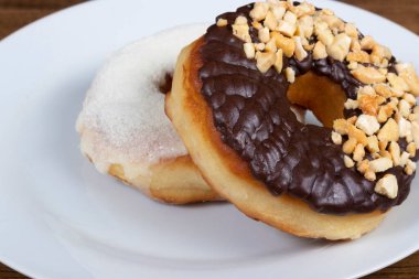 Kremalı tatlı çörekler ve süt tozlu krema ve çikolatalı ve kestane şekerli bir donut daha. Yiyecek sağda hizalandı..