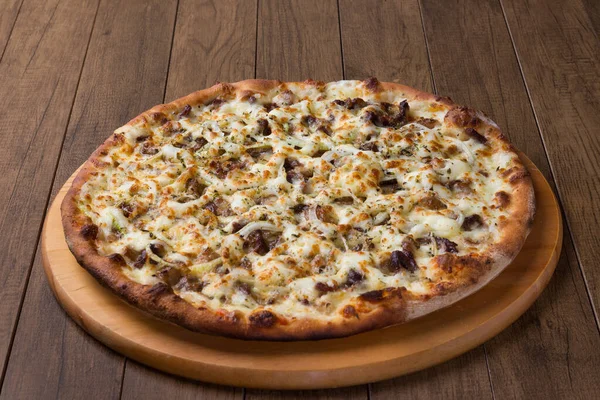 Delicious meat pizza on wooden board. Made with Mozzarella, picanha meat, onion, cheese, tomato sauce. Filet Steak, meat. Centralized.