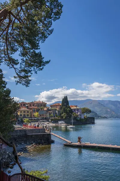 stock image Scenic view of beautiful colorful town of Varenna on the eastern shore of Lake Como, Italy against blue sky with clouds