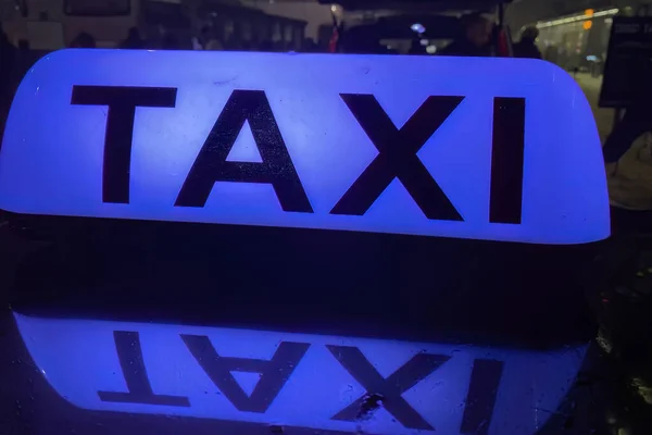 Blue Taxi sign in Poland on top of a car
