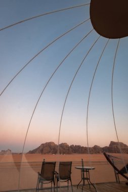 Wadi Rum çölünde gün doğumu bir kabarcık çadırının tepesinde görüldü.