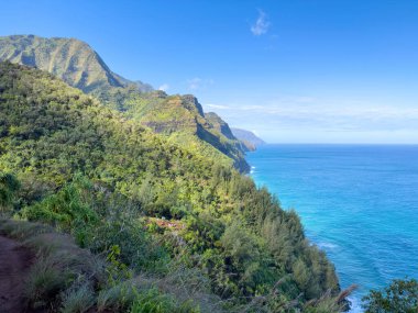 Kalalau Patikası, Kauai, Hawaii, ABD 'den görülen muhteşem Napali Sahili manzarası sabah bulutlu mavi gökyüzüne karşı