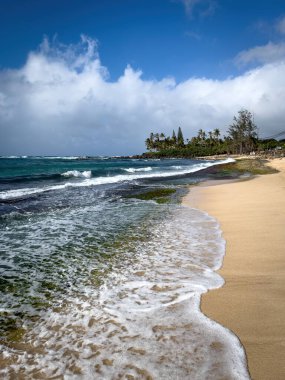 Oahu, Hawaii, ABD 'deki Laniakea Sahili manzaralı bulutlu mavi gökyüzüne karşı