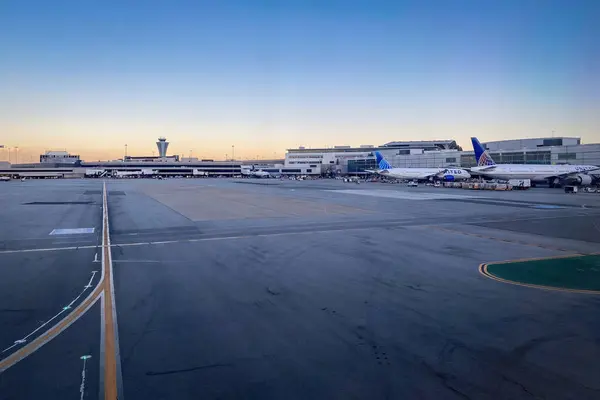 stock image San Francisco, California, USA - July 25, 2022: Apron and airport building at SFO International Airport against blue sky