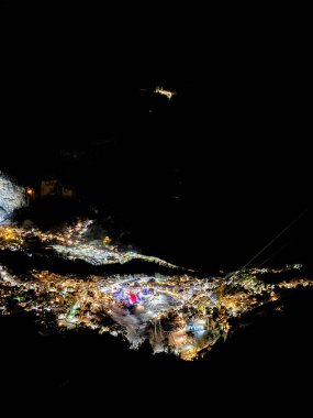 Aerial of illuminated Wengen, Switzerland at night in Winter clipart