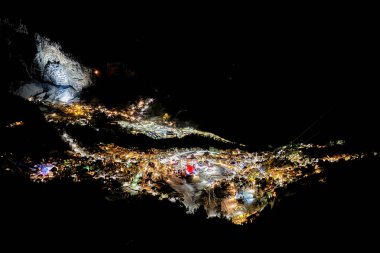 Aerial of illuminated Wengen, Switzerland at night in Winter clipart