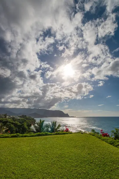 Hawaii 'nin Kauai adasının kuzey kıyısının manzarası öğleden sonra ünlü Napali kıyılarıyla bulutlu mavi gökyüzüne karşı.