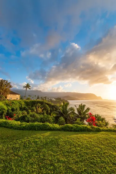 Hawaii 'nin Kauai adasının kuzey kıyısının manzarası. Gün batımında ünlü Napali kıyıları ile bulutlu mavi gökyüzüne karşı.
