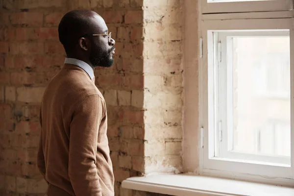 Vakava Mietteliäs Nuori Afroamerikkalainen Mies Silmälaseissa Katselee Ikkunasta Ajatellessaan Uutta — kuvapankkivalokuva