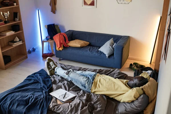 Relaxed African American Student Boy Lying Headphones Bed Own Room — Stock Photo, Image