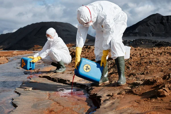 Ecological Scientist Biohazmat Suits Rubber Boots Pouring Toxic Reagent Polluted Stock Photo