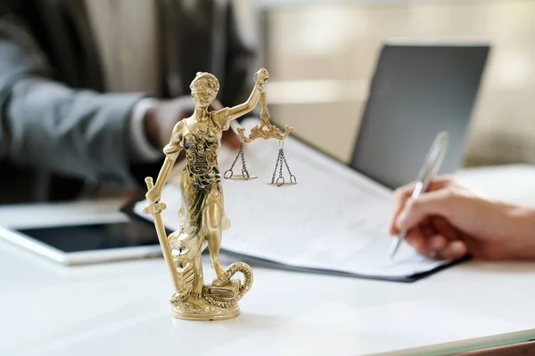 stock image Close-up of Goddess of justice stnding on workplace of lawyer in office