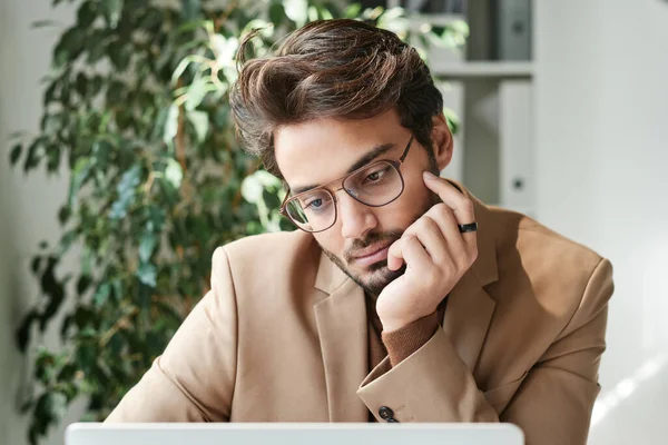 Pensativo Joven Empresario Oriente Medio Gafas Cogidas Mano Barbilla Mientras —  Fotos de Stock