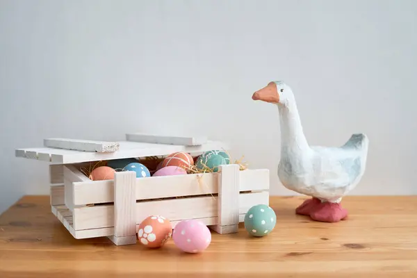 Cute duck figurine protecting Easter eggs