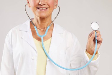 Tıbbi muayene sırasında laboratuvar önlüklü gülümseyen kadın kardiyologların yakın plan fotoğrafları.