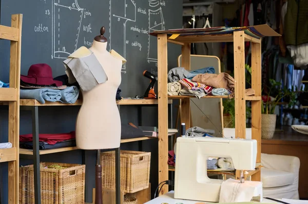 Background image of mannequin and sewing patterns in atelier studio workshop copy space