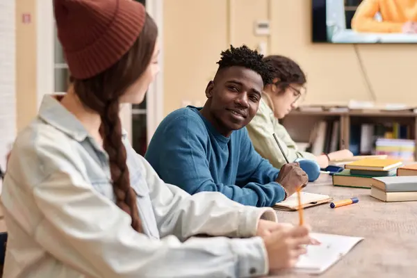 stock image Portrait of African American young man smiling at friend during group study or college class copy space