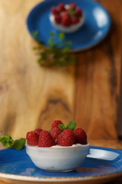 Raspberries Yogurt Glass Bowl Blue Plate Wooden Table — Stock Photo, Image