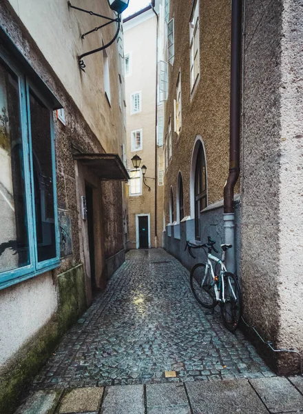 Stock image parked bike in narrow salzburg street