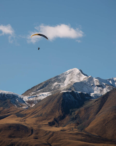Paragliding above caucasian mountains in Georgia