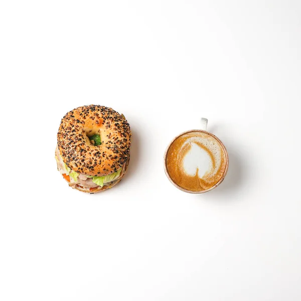 The american bagel with cup of coffee on white background