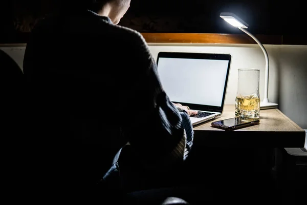 girl working on computer at home at night