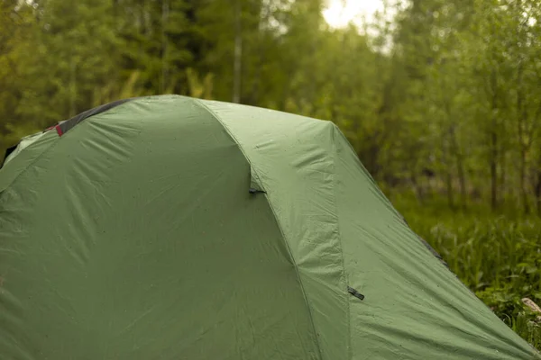 Tourist tent in forest. Tent for sleeping in nature.